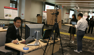 Graduate/PHD candidate students with the CBL prepare the two-dimensional biometric facial recognition display during the Borders, Trade, and Immigration Institute's 2017 Showcase Tuesday, December 5, 2017, at American University. The biometrics demonstration was one of twelve projects showcased to an audience of Department of Homeland Security personnel, non-profit think tanks, and academic institutions.